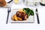Prosciutto wrapped pork: Pan roasted pork tenderloin wrapped with Italian-style dry cured ham, lathered with rich savoury sage pan gravy. Served with soft golden polenta, caramelized green apple, and broccolini florets